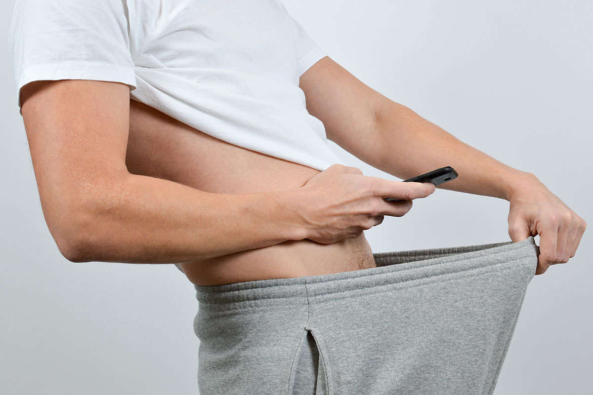 Man taking a picture of his penis with a smart-phone