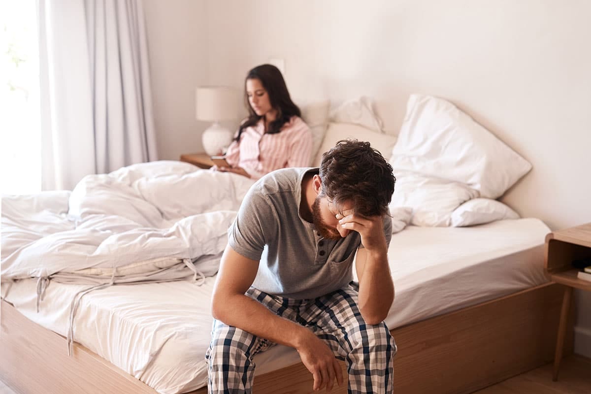 Bedroom, couple and sad man with problem, marriage conflict or stress over fail, depression or insomnia