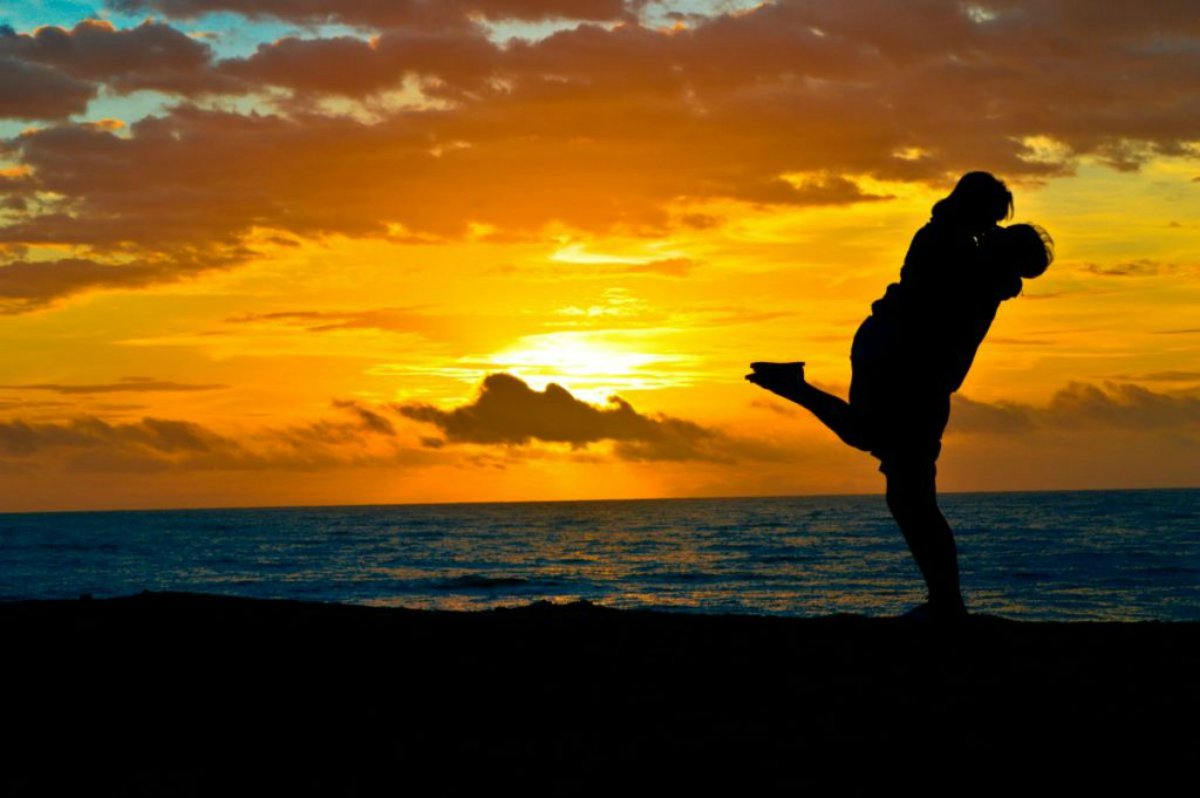 Silhouette of a happy couple during sunset